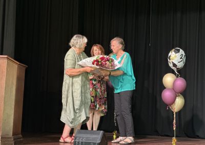 Edith Cuffe presented with a gift from Ann Baille and Andrae Pilcher